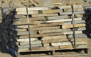 Stacks of stone tiles on wooden pallets
