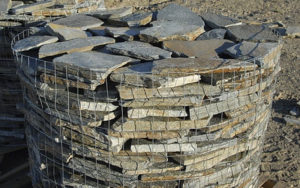 Wired barrel holding stacks of stone tiles