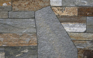 A gray and bronze stone wall