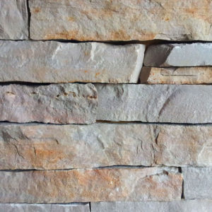 A gray and bronze stone wall