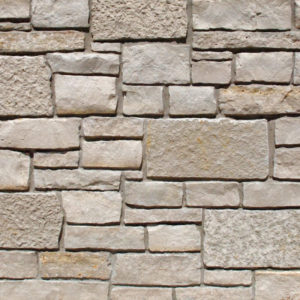 A wall with beige blocks
