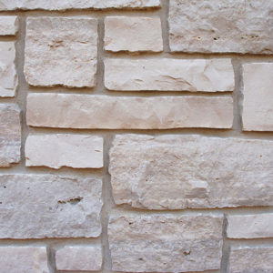 A wall with light brown blocks