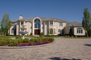 A mansion with a garden and a driveway