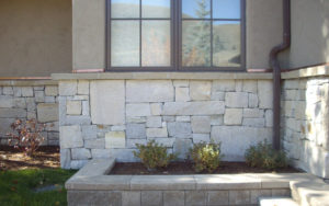 A mini garden with a stone wall